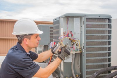 The technician checking an AC unit in outdoor at Tampa, FL