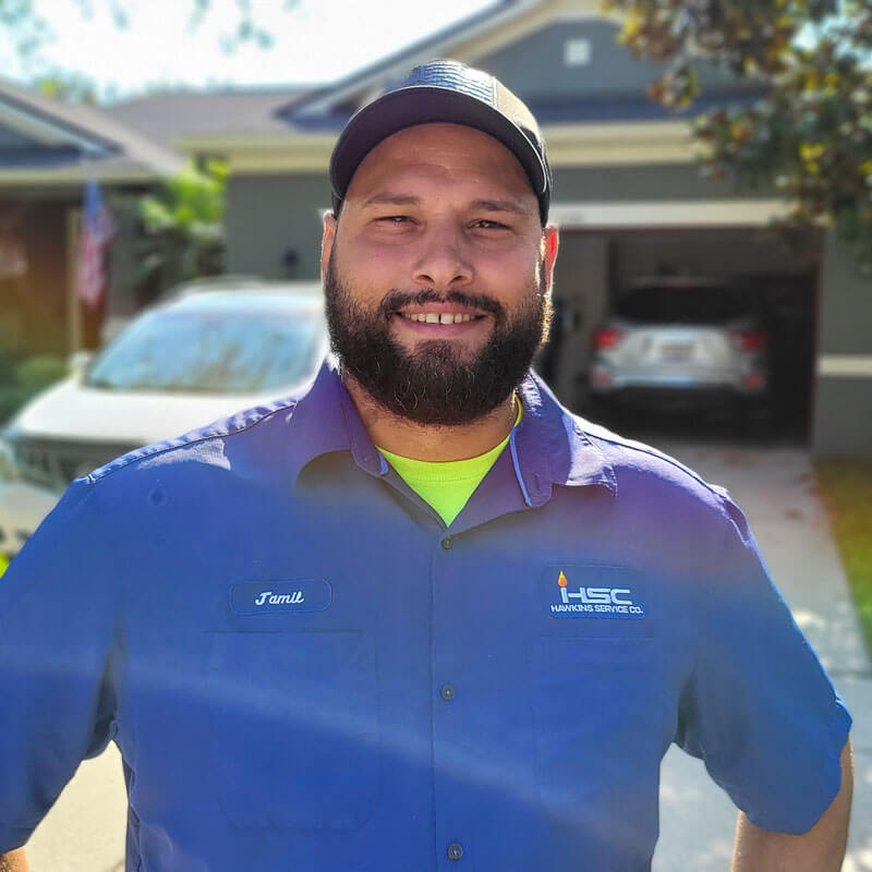 AC technician in front of customer home