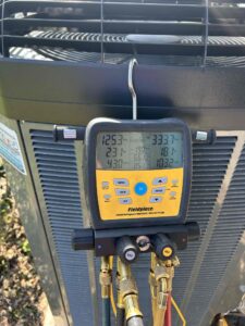 AC maintenance tool showing a readout of data on the system
