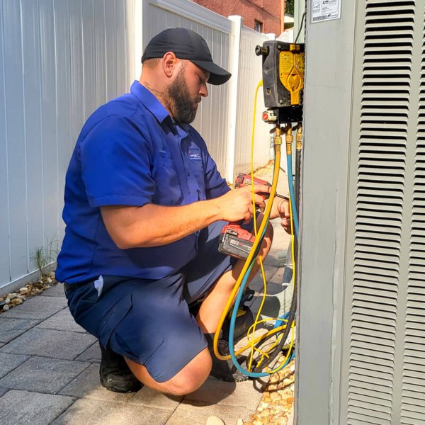 ac repair technician working on ac unit
