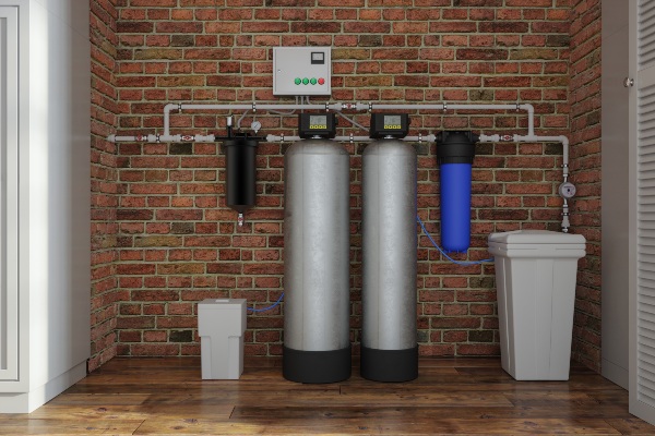 Whole-house water filter system installed on an exposed brick wall