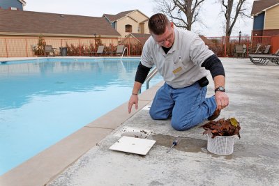 Hawkins Service Company pool technician fixing a broken pump
