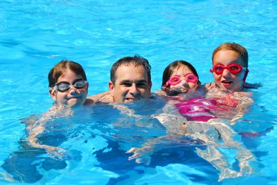 family swimming in the pool