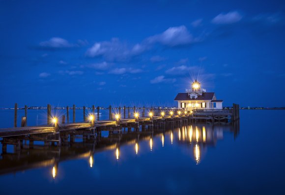 night view of dock on ocean