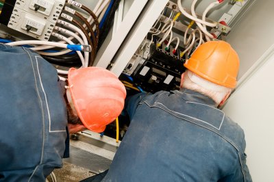 two men working on electrical wiring