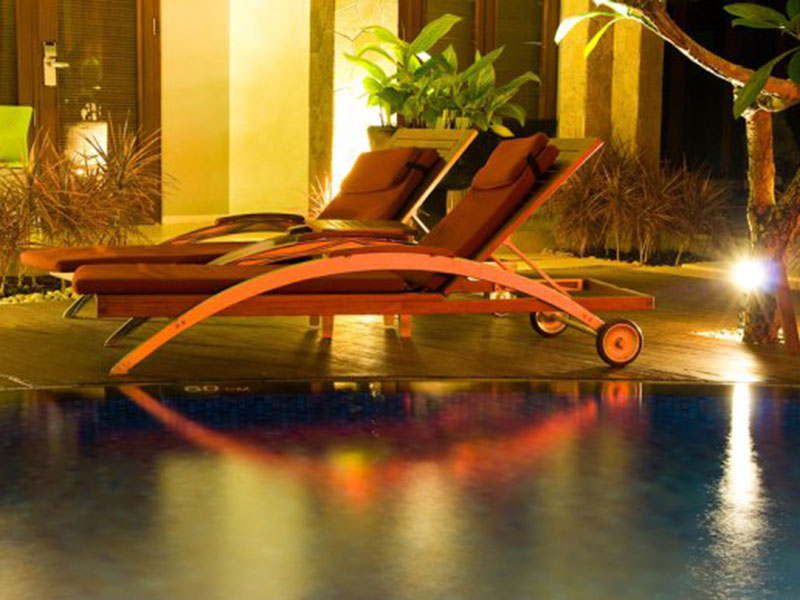 Relaxing chair near swimming pool with lighting at Tampa, FL