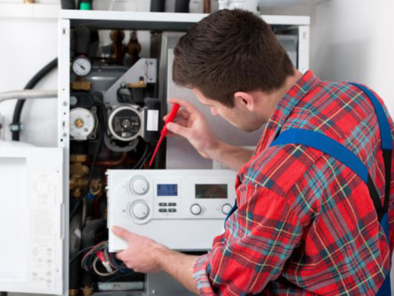 A Technician repairing a heater controller