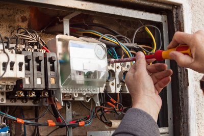 Electrician repairing electrical board