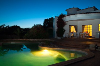 night view of the pool and hosue