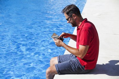 a man using phone near pool