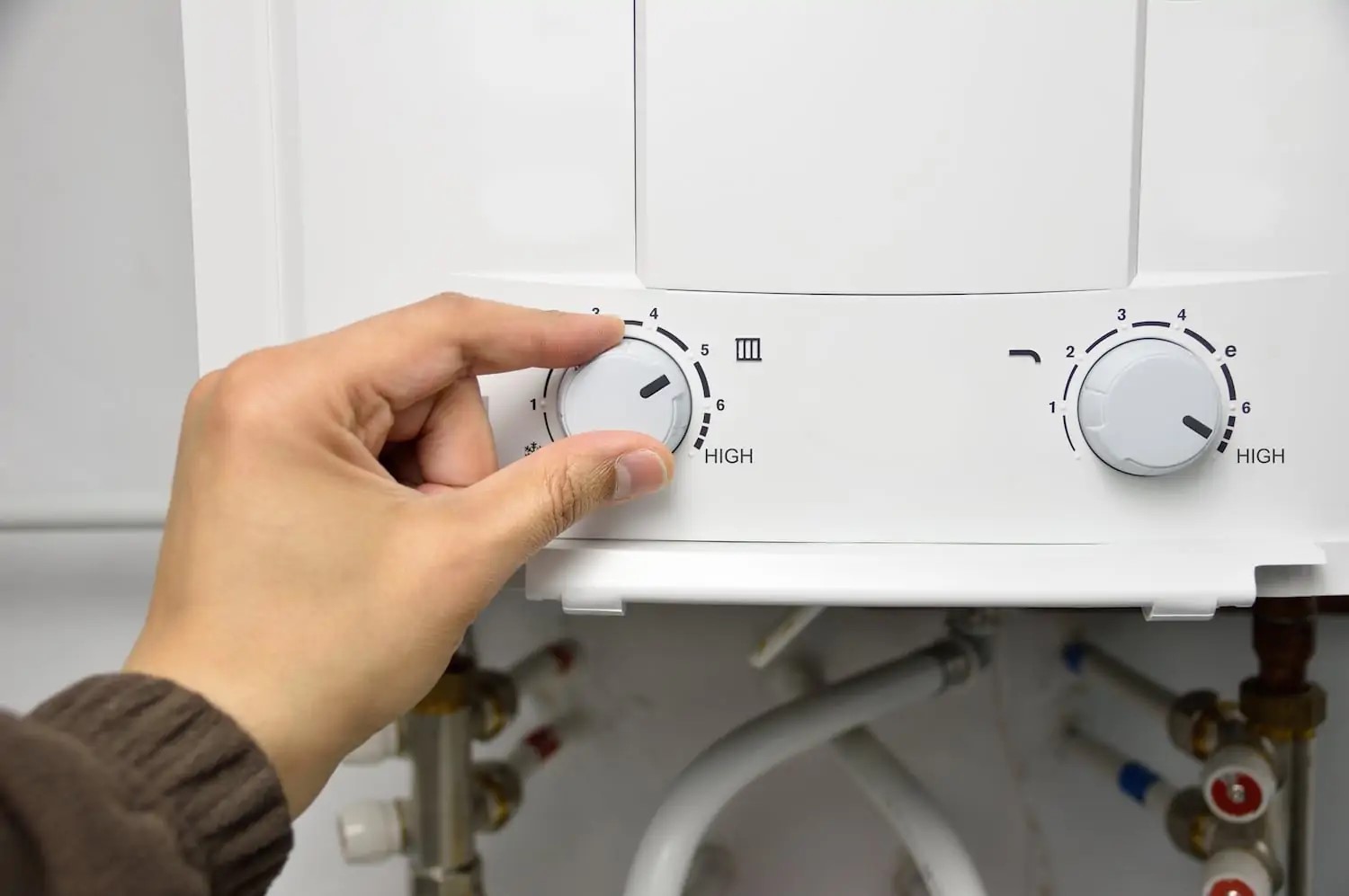 Homeowner adjusting settings on water heater
