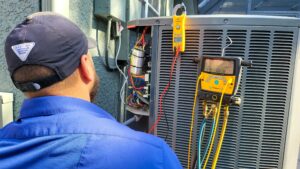 A technician looking at a ac unit condenser unit