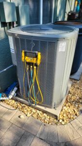 a grey machine with yellow wires