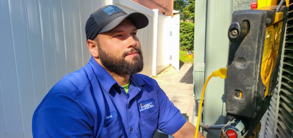 AC technician repairing a condenser unit in Clearwater, FL