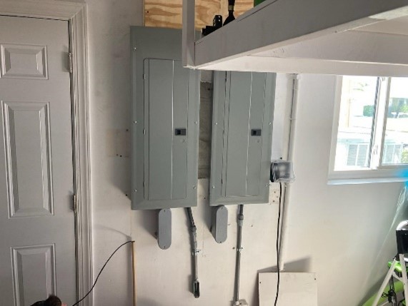 Two electrical panels installed in customer's garage