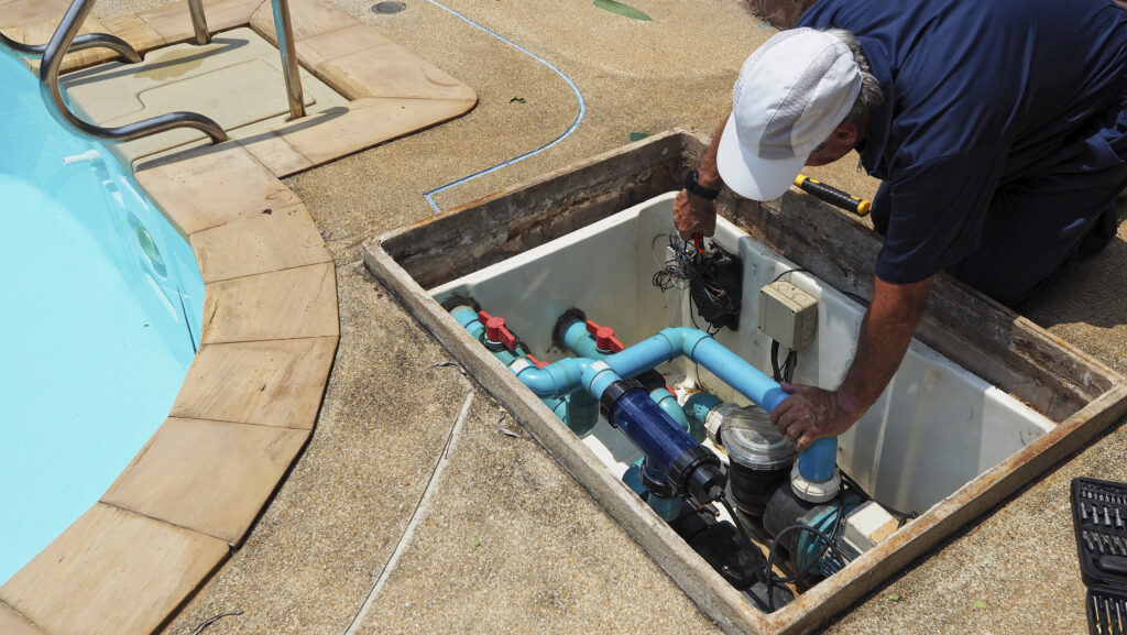 Technician fixing swimming pool water pump