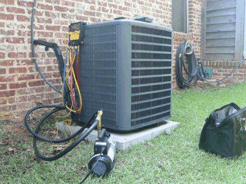 An air conditioner being worked on outside a home