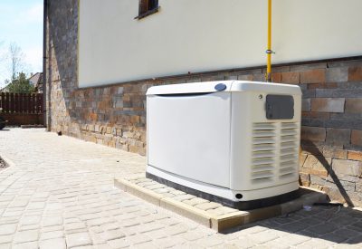 Whole-house gas generator unit outside a home