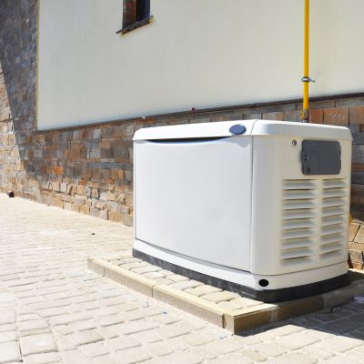 Whole-house gas generator unit outside a home
